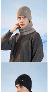 Close-up of winter knit hat and neck warmer set with ribbed texture and OK metal badge