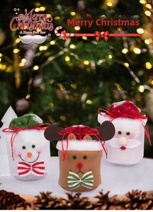 Three plush Christmas drawstring gift bags featuring snowman, reindeer and Santa designs