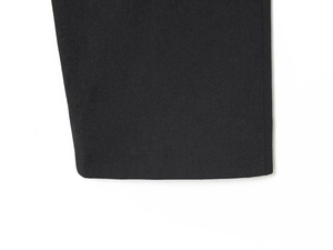 Detailed close-up of a black jacket cuff with professional flat hem stitching texture
