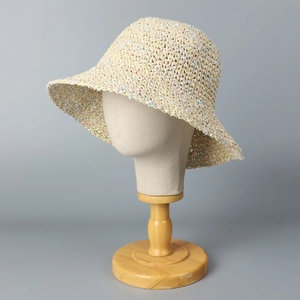 Detailed view of handmade crochet straw sun hat with colorful thread accents