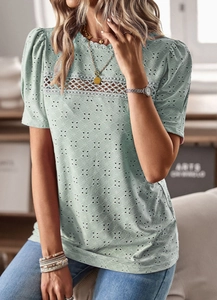 Detail of light green short sleeve top with hollow embroidery and lace patchwork
