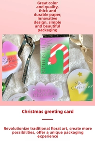 Detailed view of colorful Christmas greeting cards with ribbons on a soft plush background