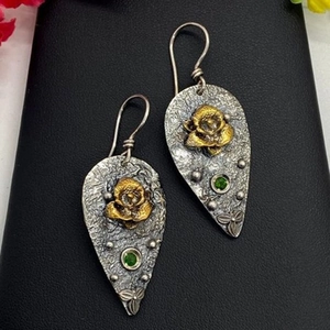 Vintage style gold flower drop earrings with green faceted stone and textured metal finish