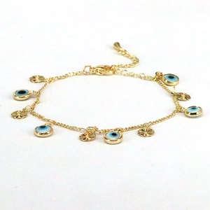 Gold evil eye bracelet featuring blue charms and circular metal discs with extender