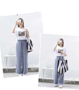 Artistic white T-shirt and blue cotton linen wide-leg trousers with a striped canvas tote