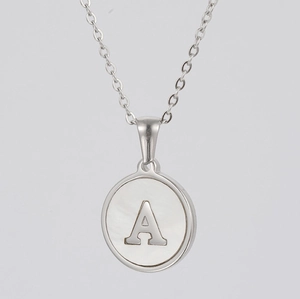Detailed view of silver letter A necklace pendant with white pearl shell inlay