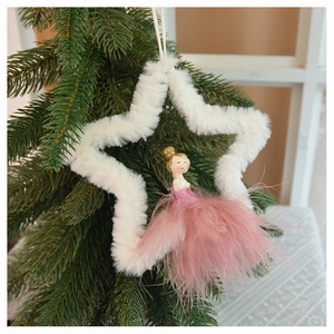 Close-up of a white plush star ornament with a pink feather fairy on a Christmas tree