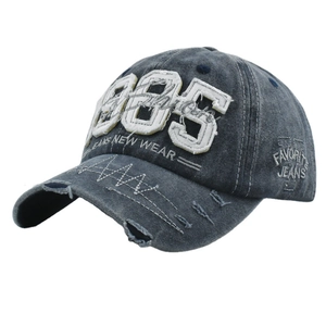 Vintage 1985 embroidered washed denim baseball cap with distressed hole design