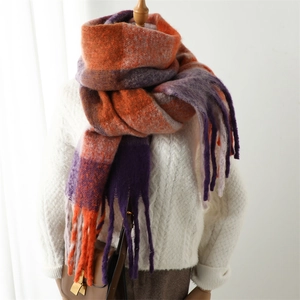 Close-up of rainbow plaid scarf with thick tassels and soft cashmere-like texture