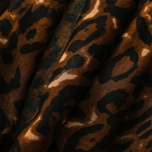 Close-up of leopard print fabric texture on a soft cotton linen blend scarf shawl