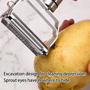 Stainless steel 2-in-1 peeler for potatoes with side eye remover on marble background