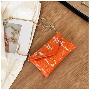 Detail view of orange crocodile pattern PU leather envelope bag with gold chain strap