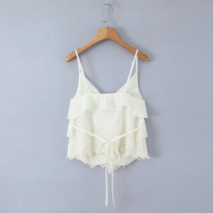 Detail of white tiered ruffle camisole with delicate eyelet embroidery lace and straps