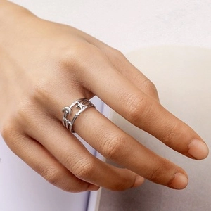 Detail showing elegant silver moon and star hollow double-line ring on a hand