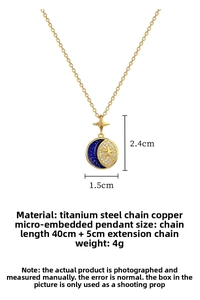 Detailed view of gold star and crescent moon pendant with blue glaze and micro-inlaid crystals