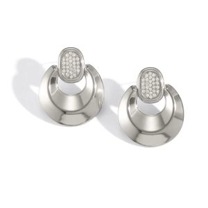 Close-up of crescent-shaped silver earrings with sparkling crystal-encrusted studs