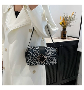 Detailed view of leopard print crossbody bag with stylish geometric metal buckle hardware
