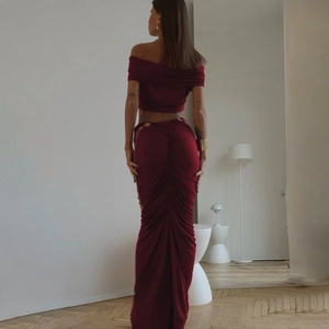 Rear view of burgundy off-shoulder crop top and ruched maxi skirt two-piece set