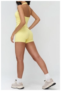 Detail view of brushed yellow yoga set with racerback top and tight sports shorts