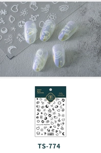 Detail showing TS-774 nail stickers with galaxy patterns and astronaut designs