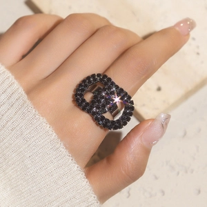 Detail shot of a glamorous double-link open ring featuring pavé-set black crystals