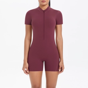 Close-up of deep red short sleeve athletic jumpsuit with half-zipper front details