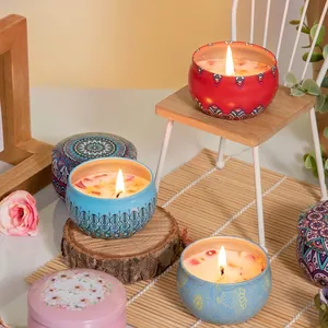 Scented candles set in mandala metal jars on a wooden stand with floral decoration