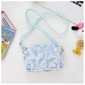 Detail of light blue floral lace crossbody bag with 3D flowers and golden metal hooks