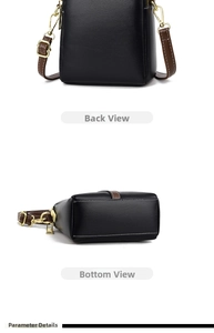 Detail view of the black crossbody bag showing its flat base and rear side structure