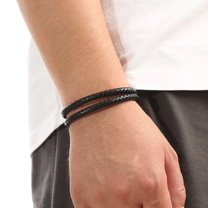 Close-up of a double-layer black braided leather bracelet for men with a magnetic clasp