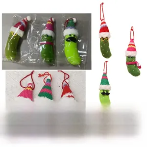 Detail view of funny plush Christmas pickles wearing knitted hats and cozy scarves