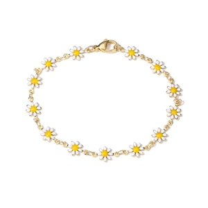 Detailed view of a gold chain bracelet with twelve white enamel daisy flower charms