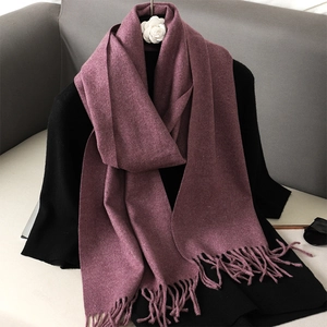 Detail shot of the mauve pink long fringe scarf with soft cashmere-like texture fabric
