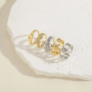 Detail of gold and silver textured rings with evil eye and star motifs on stone