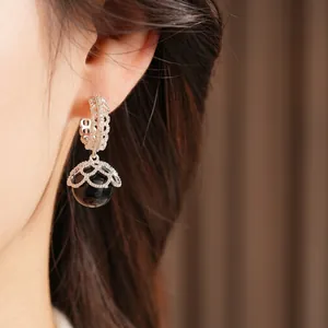 Vintage style gold plated earrings with lace metalwork, zircons and black pearls