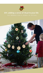 Father and son decorating a Christmas tree with round wooden DIY hanging ornaments