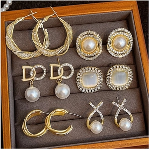 Elegant 6-piece gold alloy earring set with pearls and crystals in a velvet display tray