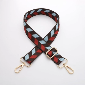 Detail of adjustable brown nylon shoulder strap with red and blue geometric patterns