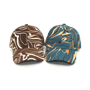 Detailed macro view of colorful marble print baseball caps with high-quality fabric texture