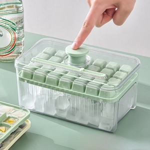 Macro detail of mint green ice cube tray set with press-to-release lid and scooper