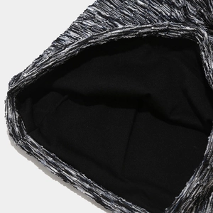 Macro shot of tie-dye knit hat featuring black and white texture with soft black lining