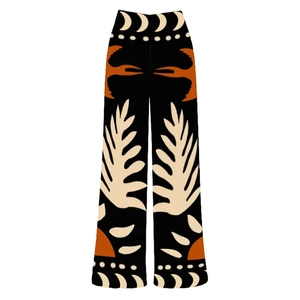 Detail of ethnic pattern print on high-waist wide-leg pants featuring feather and moon motifs