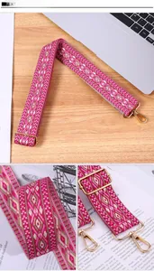Close-up of ethnic geometric woven strap with gold metal lobster clasp and adjuster