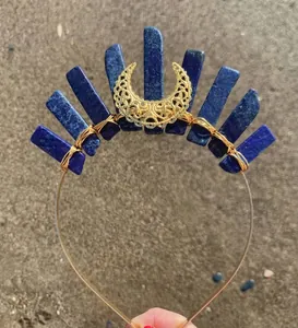 Detail of handmade bohemian crown with blue crystals and a golden crescent moon