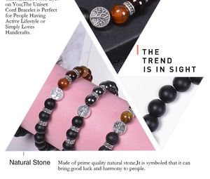 Macro detail of natural tiger eye and lava stone bracelets with tree of life charms