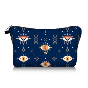 Detailed view of evil eye pattern on dark blue travel cosmetic bag with zipper