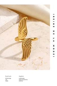 Detail of golden adjustable wing ring with textured feathers on white stone and silk