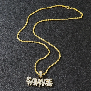 Detail of gold SAVAGE pendant with iced out rhinestones on a twisted rope chain