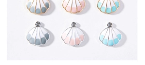 Macro view of colorful enamel shell charms with gold and silver metal frames for DIY jewelry