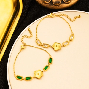 Detailed close-up of 18K gold plated clover bracelets with emerald and zircon stones